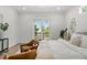 Comfortable primary bedroom features a private balcony, neutral decor, and natural light from the large sliding glass door at 500 E Davis Blvd, Tampa, FL 33606