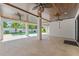 Covered patio boasts ceiling fans, tile floor and an outdoor view of the beautiful pool at 500 E Davis Blvd, Tampa, FL 33606
