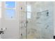 Elegant bathroom shower with marble-look tile, glass door, and built-in niche; a luxurious spa-like experience at 500 E Davis Blvd, Tampa, FL 33606