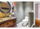 This bathroom has an antique style vanity with marble countertop and a toilet at 5051 5Th S Ave, St Petersburg, FL 33707