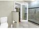 This bathroom has an easy access shower and toilet with gold fixtures at 5051 5Th S Ave, St Petersburg, FL 33707