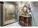 This bathroom has a glass shower and an antique style vanity with marble countertop at 5051 5Th S Ave, St Petersburg, FL 33707