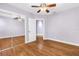 Spacious bedroom with hardwood floors, ceiling fan, and mirrored closet at 5051 5Th S Ave, St Petersburg, FL 33707
