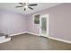 This bedroom has tile floors, a ceiling fan, and a glass exterior door at 5051 5Th S Ave, St Petersburg, FL 33707