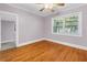 This bedroom has hardwood floors, a large window, and neutral-toned walls at 5051 5Th S Ave, St Petersburg, FL 33707