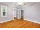 This bedroom has hardwood floors, a ceiling fan, and double mirrored closet doors at 5051 5Th S Ave, St Petersburg, FL 33707