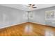 This bright bedroom features hardwood floors, a ceiling fan, and multiple windows at 5051 5Th S Ave, St Petersburg, FL 33707