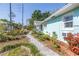 Exterior of the home features a white gravel walkway and flower garden at 5051 5Th S Ave, St Petersburg, FL 33707