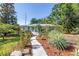 Attractive single-story home with vibrant landscaping and a welcoming pathway to the entrance at 5051 5Th S Ave, St Petersburg, FL 33707