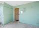 Charming front porch entrance with light-green exterior, decorative light fixture and mailbox at 5051 5Th S Ave, St Petersburg, FL 33707