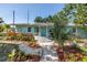 Charming single-story home featuring a well-manicured front yard with lush landscaping and a welcoming walkway at 5051 5Th S Ave, St Petersburg, FL 33707