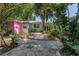 Charming, colorful home with lush landscaping and a stone pathway leading to the entrance at 5051 5Th S Ave, St Petersburg, FL 33707