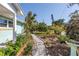 Charming cottage-style home with a quaint gravel path lined with flowers at 5051 5Th S Ave, St Petersburg, FL 33707
