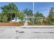 Charming cottage-style home with blooming flowers and a walkway at 5051 5Th S Ave, St Petersburg, FL 33707
