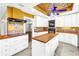 Bright kitchen featuring white cabinetry, decorative backsplash, and a convenient island at 5051 5Th S Ave, St Petersburg, FL 33707