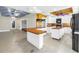 Open-concept kitchen featuring ample counter space and cabinetry, adjacent to a spacious living area at 5051 5Th S Ave, St Petersburg, FL 33707