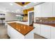 Island kitchen featuring custom cabinetry, modern appliances, and an open layout perfect for entertaining at 5051 5Th S Ave, St Petersburg, FL 33707
