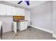 Practical laundry room with white cabinets, tiled backsplash, and sink at 5051 5Th S Ave, St Petersburg, FL 33707