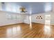 Inviting living room with hardwood floors, ceiling fan, and an open layout to other rooms at 5051 5Th S Ave, St Petersburg, FL 33707