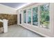 Sun room with large windows offering views of the landscaped backyard at 5051 5Th S Ave, St Petersburg, FL 33707