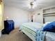 Bedroom featuring striped bedspread, blue accents, neutral walls, and ceiling fan at 5100 Aragon S Way, St Petersburg, FL 33705