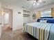 Bedroom featuring closet, neutral walls, striped bedspread, blue accents, and ceiling fan at 5100 Aragon S Way, St Petersburg, FL 33705