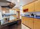 Well-lit kitchen with wooden cabinetry, a sleek stovetop, and an open design, maximizing space and functionality at 5100 Aragon S Way, St Petersburg, FL 33705