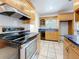 Modern kitchen with stainless steel appliances, ample counter space, and classic wooden cabinetry for culinary enthusiasts at 5100 Aragon S Way, St Petersburg, FL 33705