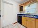 Bright kitchen features white subway tile backsplash, double sink, and black dishwasher at 5100 Aragon S Way, St Petersburg, FL 33705