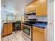 Well-equipped kitchen with stainless steel appliances and unique blue countertops with ample cabinet space at 5100 Aragon S Way, St Petersburg, FL 33705