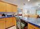 Bright and airy kitchen with wooden cabinets, a breakfast bar, and an open layout leading to the living room at 5100 Aragon S Way, St Petersburg, FL 33705