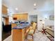 Open kitchen with breakfast bar, wooden cabinetry, and tiled floors, perfect for casual dining and entertaining at 5100 Aragon S Way, St Petersburg, FL 33705