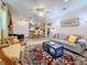 Spacious living area with a stone fireplace, seamlessly connected to a kitchen, perfect for entertaining guests at 5100 Aragon S Way, St Petersburg, FL 33705