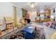Open living space featuring a stone fireplace and view into the kitchen, offering a welcoming and connected layout at 5100 Aragon S Way, St Petersburg, FL 33705