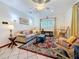 Cozy living room with neutral sofa, patterned rug, and natural lighting, creating a relaxing atmosphere at 5100 Aragon S Way, St Petersburg, FL 33705