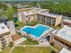 Aerial view of community amenities including a large pool, seating areas, and landscaping at 5820 N Church Ave # 326, Tampa, FL 33614