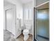 Bright bathroom with a toilet, glass-enclosed shower, and a frosted window for privacy at 5877 33Rd N Ave, St Petersburg, FL 33710