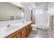 Bright bathroom featuring a double sink vanity, large mirror, and combined shower-tub at 5877 33Rd N Ave, St Petersburg, FL 33710