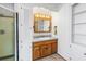 Charming bathroom featuring a wooden vanity, ample storage, and neutral tile flooring at 5877 33Rd N Ave, St Petersburg, FL 33710
