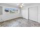 Bright bedroom with tile flooring, white walls, ceiling fan, and double closets at 5877 33Rd N Ave, St Petersburg, FL 33710
