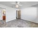 Bedroom featuring white walls, tile flooring, with an adjoining bathroom and closets at 5877 33Rd N Ave, St Petersburg, FL 33710