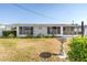 Charming single-story home with picture window, mature landscaping, and beautiful concrete bird bath at 5877 33Rd N Ave, St Petersburg, FL 33710
