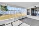 Enclosed porch featuring tiled floor, screened walls, and door to the backyard at 5877 33Rd N Ave, St Petersburg, FL 33710