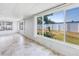 Sunroom with large windows offering backyard views of the lawn and fence at 5877 33Rd N Ave, St Petersburg, FL 33710
