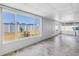 Sunroom with large windows offering views of the backyard and white picket fence at 5877 33Rd N Ave, St Petersburg, FL 33710