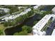 Aerial view of the condo complex with lake and trees throughout the complex at 5970 80Th Street North # 206, St Petersburg, FL 33709