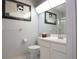 Bathroom featuring a toilet, vanity, mirror, and glass shower at 5970 80Th Street North # 206, St Petersburg, FL 33709
