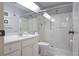 Bright bathroom with a glass-enclosed shower, marble vanity, and modern fixtures at 5970 80Th Street North # 206, St Petersburg, FL 33709