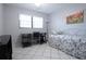 Light and airy bedroom featuring a daybed, desk, and large window at 5970 80Th Street North # 206, St Petersburg, FL 33709