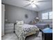 Bright bedroom with two beds, ceiling fan, tile floor, and natural light from the window at 5970 80Th Street North # 206, St Petersburg, FL 33709